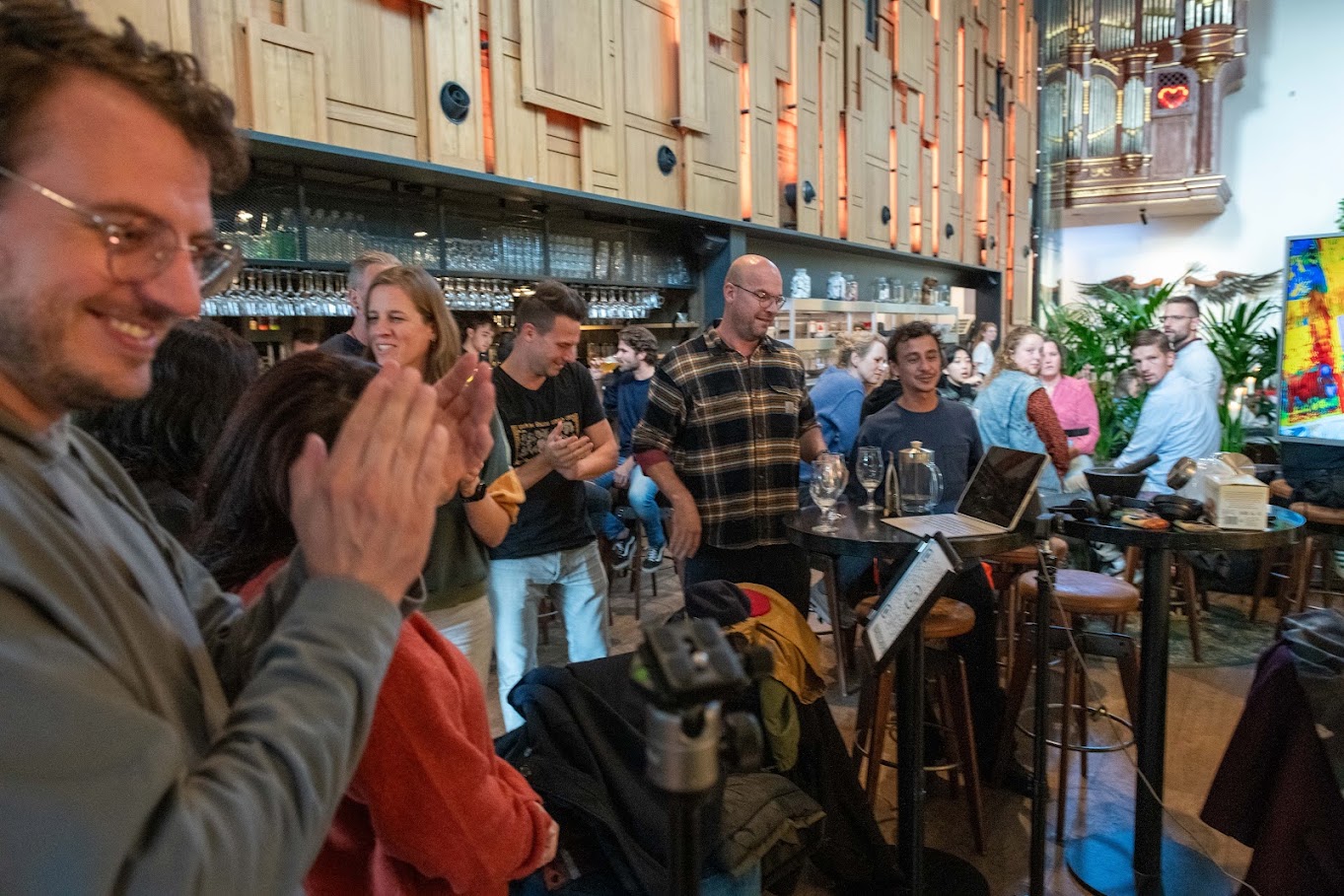 Visitors smiling and applauding during a live painting performance.