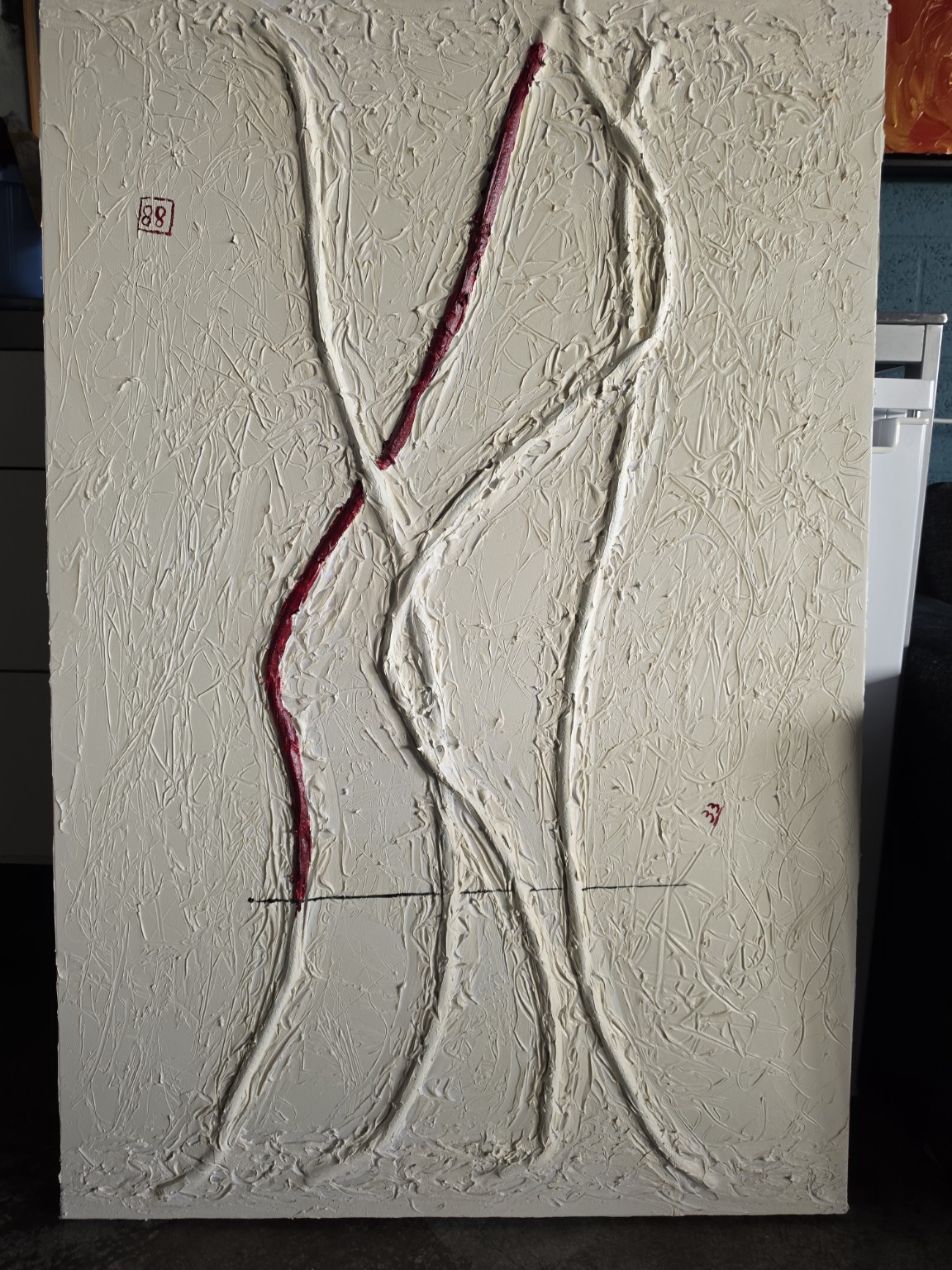 A white relief canvas with branching lines and a red accent, photographed in the studio.